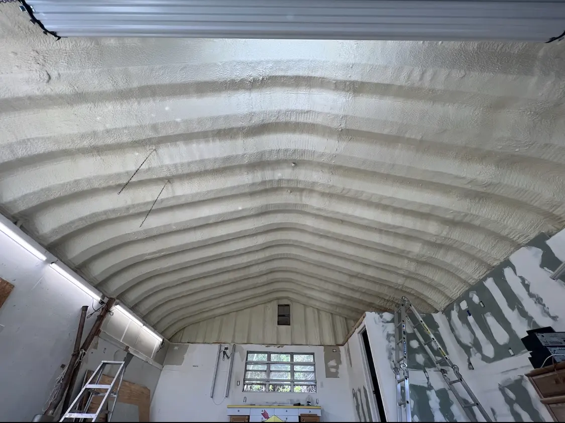 Spray polyurethane foam applied to the underside of a metal roof deck in Newfane
